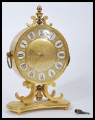 A vintage 20th century Junghans Meister brass cased mantel clock having a gilt dial with faceted