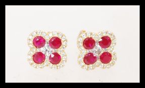 A pair of contemporary 18ct rose gold ruby and diamond four leaf clover earrings of 1.4ct's. Earring