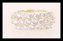 A hallmarked 9ct yellow gold cluster ring having white stones in a prong setting.  Hallmarked