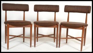 A set of three teak G-plan dining chairs designed by Koford Larsen. Raised on tapered turned legs