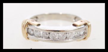 A contemporary 10ct white gold diamond half eternity style ring with gold decoration and 8 channel