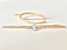 Two 9ct gold brooches one being an Art Deco bar brooch with central oval cut aquamarine flanked by