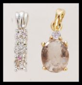 Two gold necklace pendants one 9k white gold set with diamond clusters, hallmarked Birmingham. The