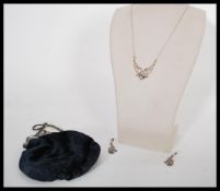 A group of Art Nouveau jewellery to include small purse with embossed white metal clasp and a