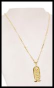 An 18ct gold flat link necklace and Egyptian pendant with hieroglyphics crested with wings, the c-