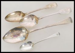 A group of four Georgian and Victorian silver hallmarked spoons to include a Georgian table