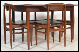 A vintage retro 20th century Elliotts of Newbury extending dining table and chairs with black
