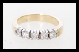 A 14 carat gold white diamond ring having 5 graduating diamonds in prong settings. The item weight