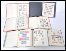 A group of seven vintage stamp albums containing World and GB stamps. Please see images.