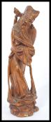 A 19th century Chinese hardwood figurine of a sage elder being hand carved and raised on pedestal