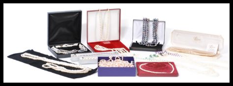 A large collection of boxed pearl and freshwater / cultured pearl necklaces. Some black and coloured