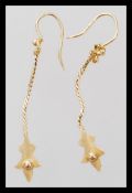 A pair of high carat 22ct gold testing drop earrings having curb linked droplets. Weighs 2 grams.