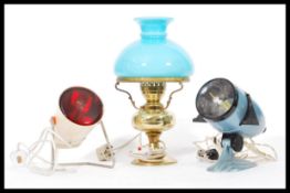 A collection of vintage 20th Century lamps to include an enamel projector, retro heat lamp and a