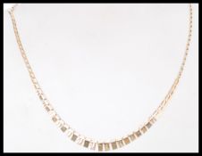 A 9k gold long curb link Cleopatra necklace having square panel droplets and bolt ring clasp. Weighs