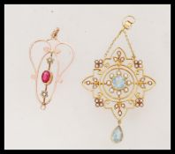 Two Edwardian necklace pendants to include a 15ct gold aquamarine and seed pearl pendant having a