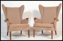 A good mid century pair of retro Parker Knoll armchairs being raised on tapering legs with
