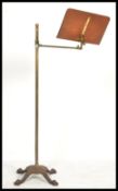A 19th century Victorian cast iron and brass reading lectern stand raised on a quad hairy paw base