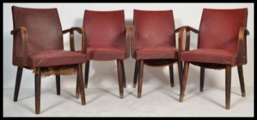 A set of four retro 20th century vintage Ben Chairs bridge type dining chairs  being raised on