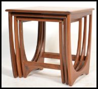 A 1970's G-Plan Kelso teak wood nest of tables. The tables of graduating form with shaped table tops