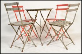 A set of vintage 20th century folding garden table and four chairs having slatted seats and back