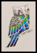 A contemporary sliver and Plique A Jour brooch in the form of an owl with marcasite and rubies.The
