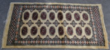 A 20th century Persian Islamic floor carpet with cream ground having red medallion detailing on