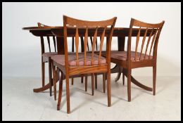 A set of four vintage retro 20th century Greaves and Thomas dining chairs raised on tapering legs