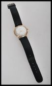 A vintage 20th century 9ct gold watch by Zenith. The silvered dial having gilt baton numerals with