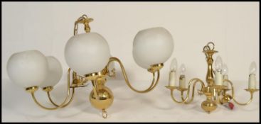 A vintage 20th Century six branch gilt brass chandelier with fitted milk glass shades together
