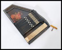 A vintage 20th century Autoharp musical instrument complete in original box with instructions.