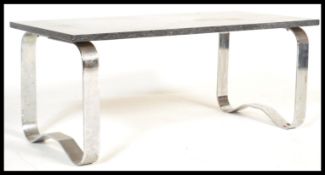 A 20th century modernists coffee table being supported by strapwork chrome base with black