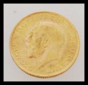 An early 20th century George V full sovereign gold coin dated 1928. Weighs 7.98 grams.