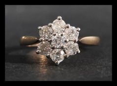 A hallmarked 9ct gold and diamond cluster ring. Di