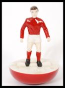 A Royal Doulton Subbuteo ceramic football figurine MCL 12 featuring a player in red and white kit on