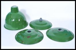 A group of vintage retro 20th century green enamel pendant UFO type shades along with another larger