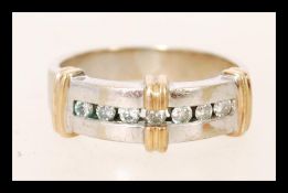 A hallmarked 9ct white and yellow gold channel set diamond band ring. Diamonds approx 14pts.