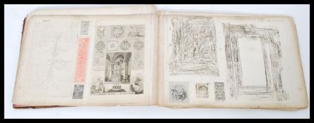 An early 20th century scrapbook containing book cover rubbings cuttings and drawings all taken