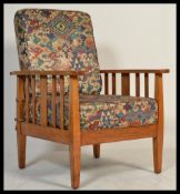 A 1930's Art Deco golden oak stick back armchair. Raised on squared legs with flat plank arm rests