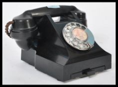 A vintage mid 20th Century bakelite phone with cheese dish and having a recent rewiring to make
