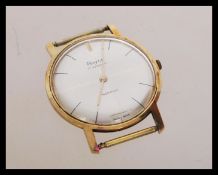 A vintage 20th century 14ct gold incabloc watch by Royce having a silvered dial with baton