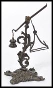 A 19th century rare bronze letter scale of unusual form raised on a scrolled base. Please see