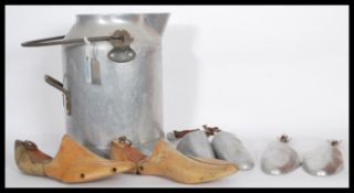 A vintage mid 20th century polished steel milk churn bucket together with a set of wooden cobblers