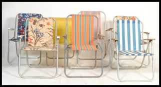 A collection of vintage retro 20th Century folding deck / garden chairs, tubular frames with