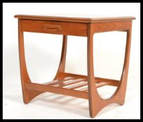 A vintage retro 20th century G-Plan teak side table with slide to front and magazine rack to base.