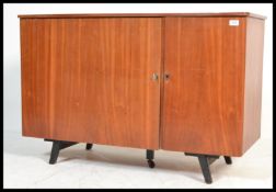 A vintage retro 20th century Danish influence teak metamorphic desk having opening action front that