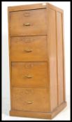 A 1940's Industrial oak 4 drawer filing cabinet. Raised on plinth base with 4 filing drawers