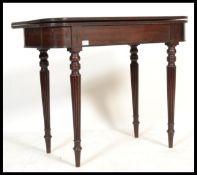An 18th century George III mahogany tea table being raised on turned legs with fitted frieze