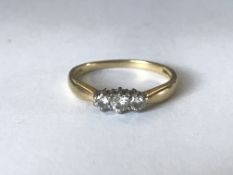 A hallmarked 18ct gold and diamond three stone ring. Diamonds approx 25pts. Hallmarked London.