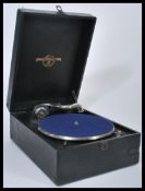 A vintage early 20th century portable picnic gramophone by Columbia, front winder , carry handle