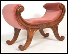 A 20th century Georgian style Regency revival mahogany window seat raised on carved bowed supports